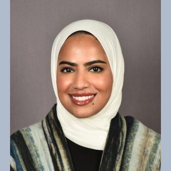 Headshot image of Dr. Mariam Alkheder, a pediatric dentist and assistant professor, wearing formal attire against a neutral background